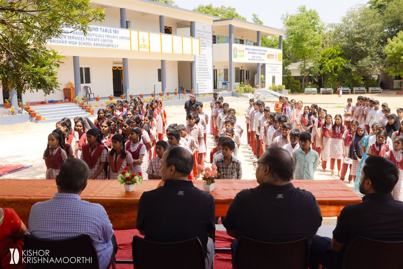Students assembled in front of the new school building