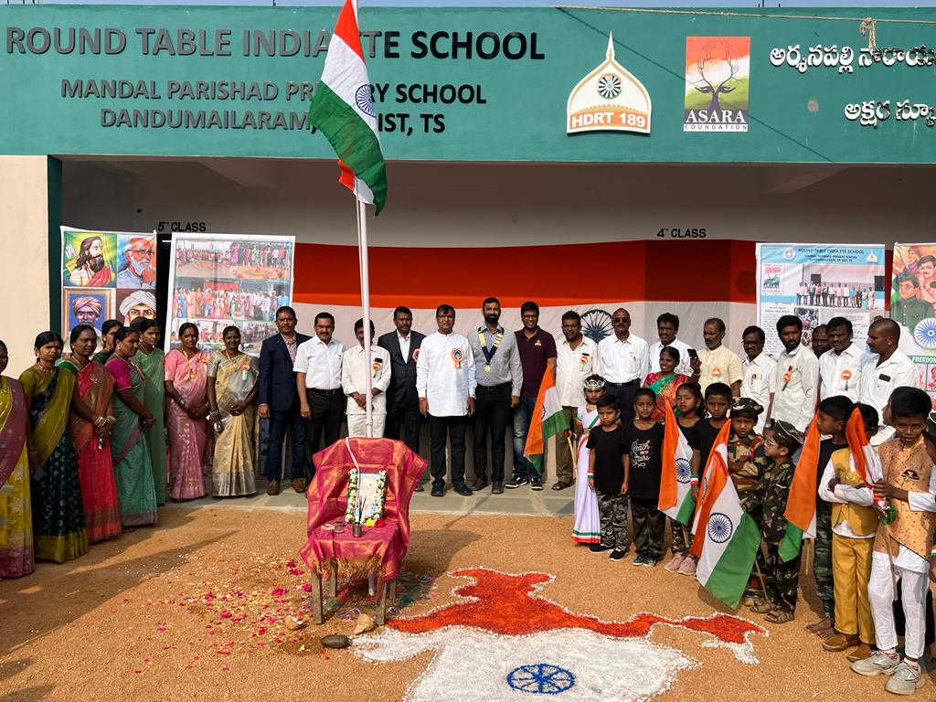 Flag hoisting in front of a Round Table India school building