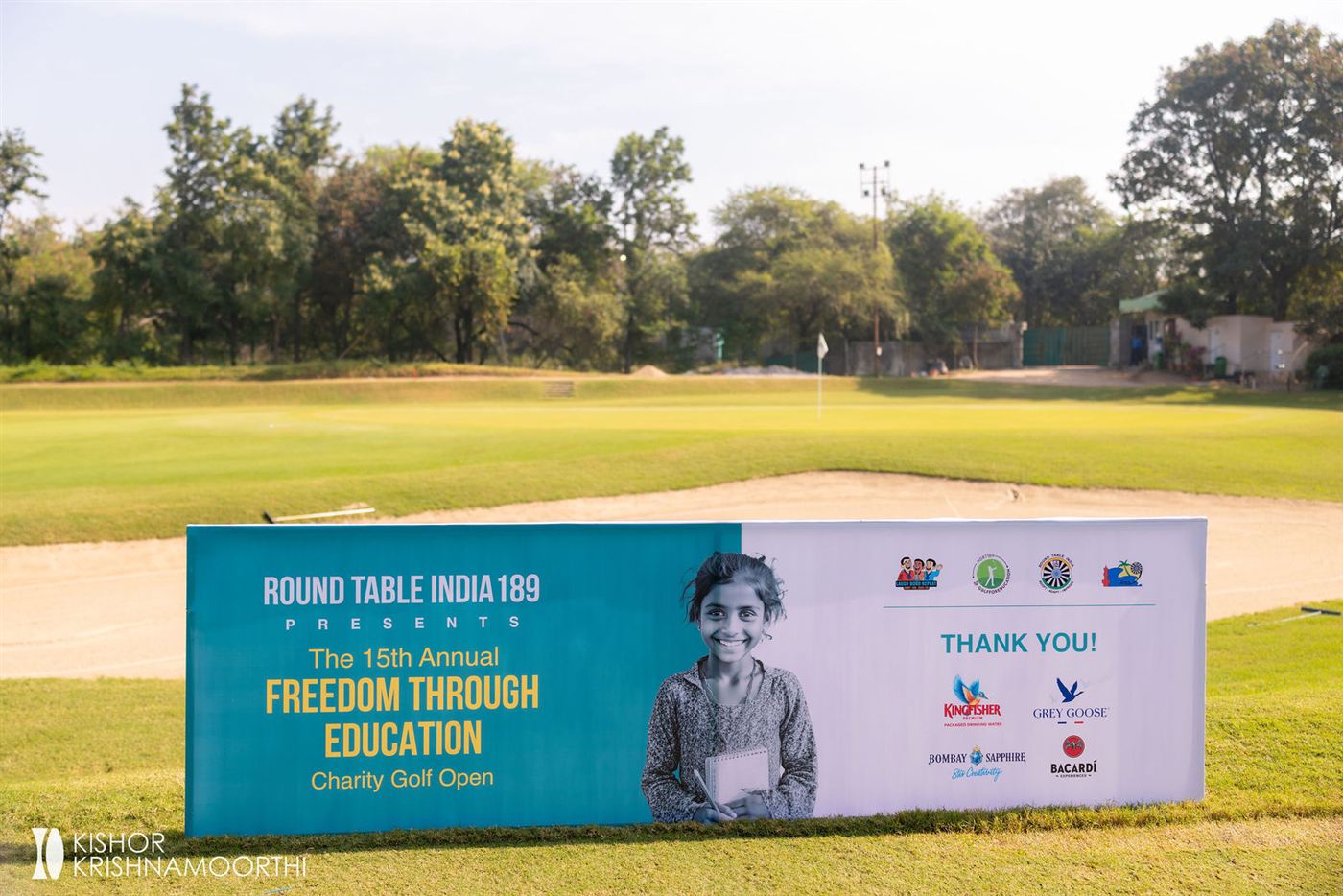 Tournament banner on the golf course reading Freedom Through Education Charity Golf Open