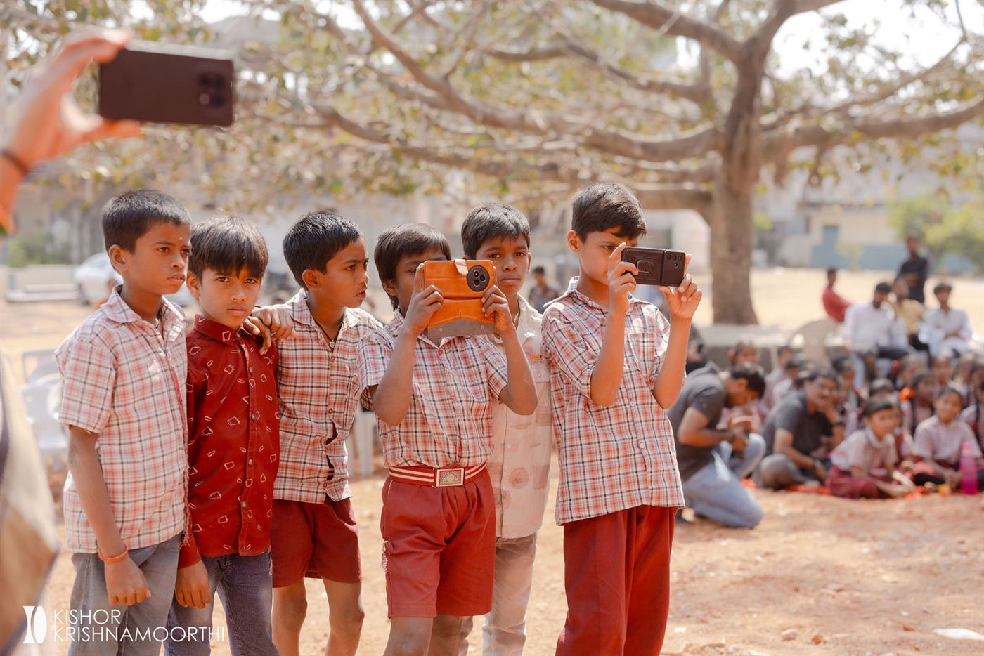 Schoolboys taking photos at the Narsapur inauguration